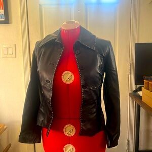 Black leather jacket with white top stitching. Women’s small.